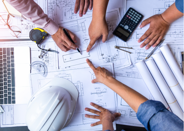 Team of engineers work on building plans